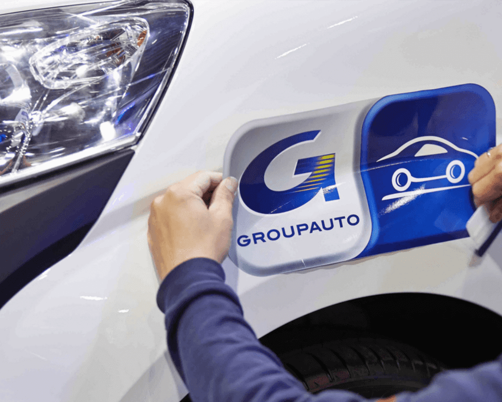 Groupauto sticker being place on a car